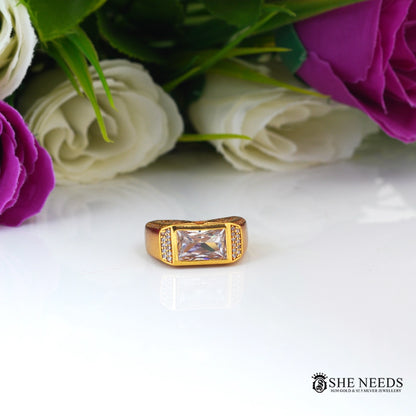 Gold-tone men's ring featuring a rectangular-cut CZ centerpiece, sparkling side stones, and intricate engraved detailing on the band.|She Needs Jewellery
