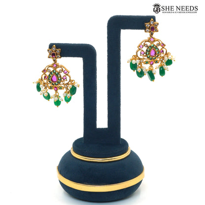 Pair of royal emerald chandelier earrings featuring green and ruby-pink stones, sparkling white stones and pearl drops|She Needs Jewellery
