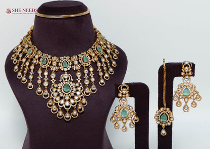 Royal Emerald Green Kundan Bridal Choker Necklace Set with Matching Earrings and Maang Tikka in Antique Gold Finish for Wedding and Bridal Wear
