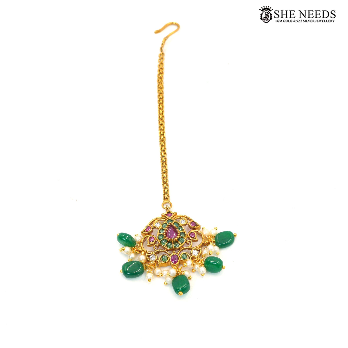 Royal emerald maang tikka with intricate gold-toned detailing, green and ruby-pink stones and pearl drop embellishments|She Needs Jewellery
