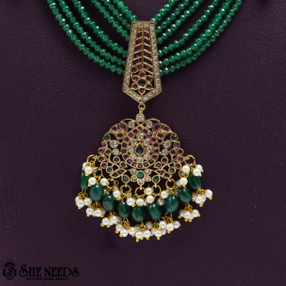 Royal Emerald Pearl Drop Earrings with emerald bead drops and pearl detailing