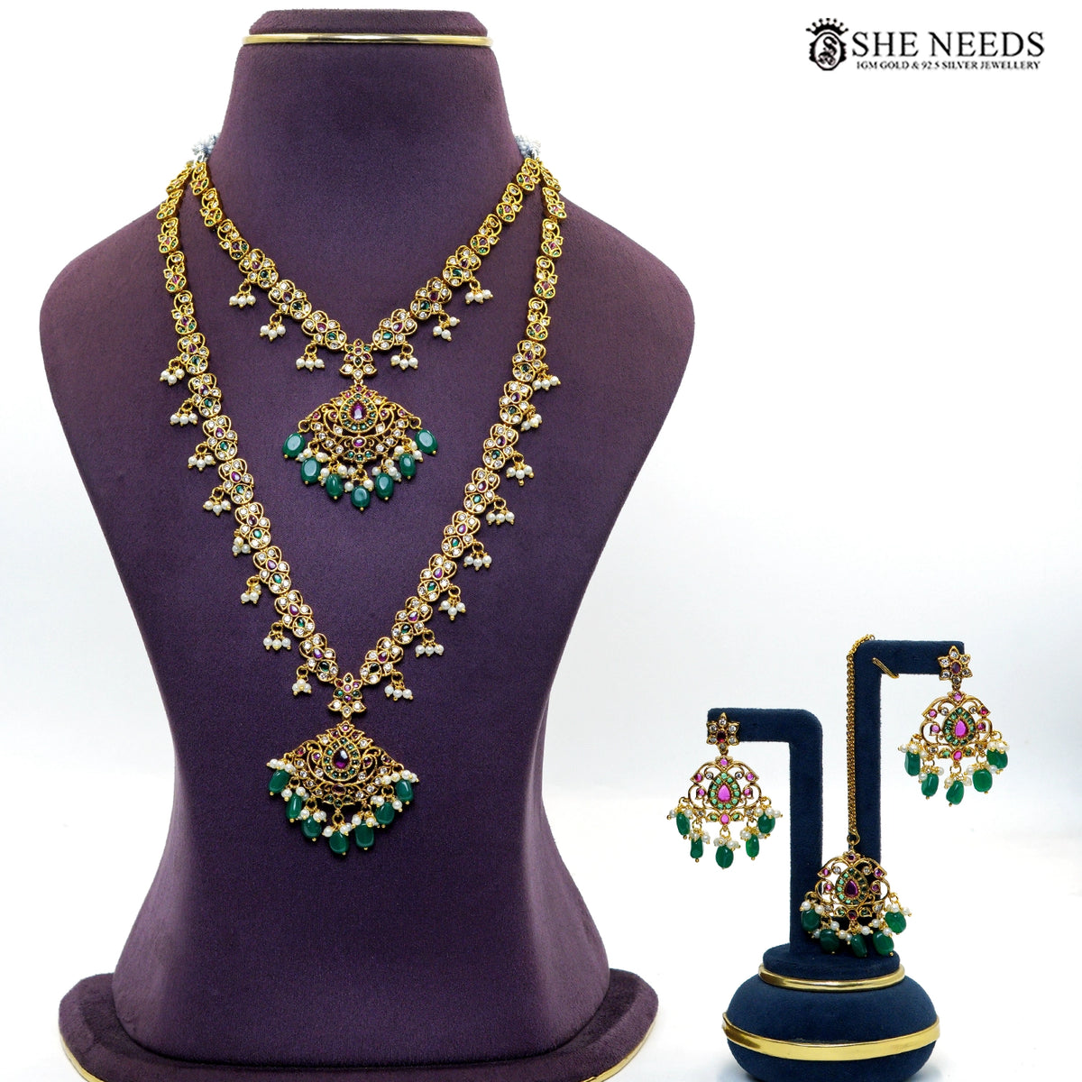 Royal gold-toned temple necklace set with intricate stonework, green emerald-style beads, ruby accents, pearl drops and matching earrings|She Needs Jewellery
