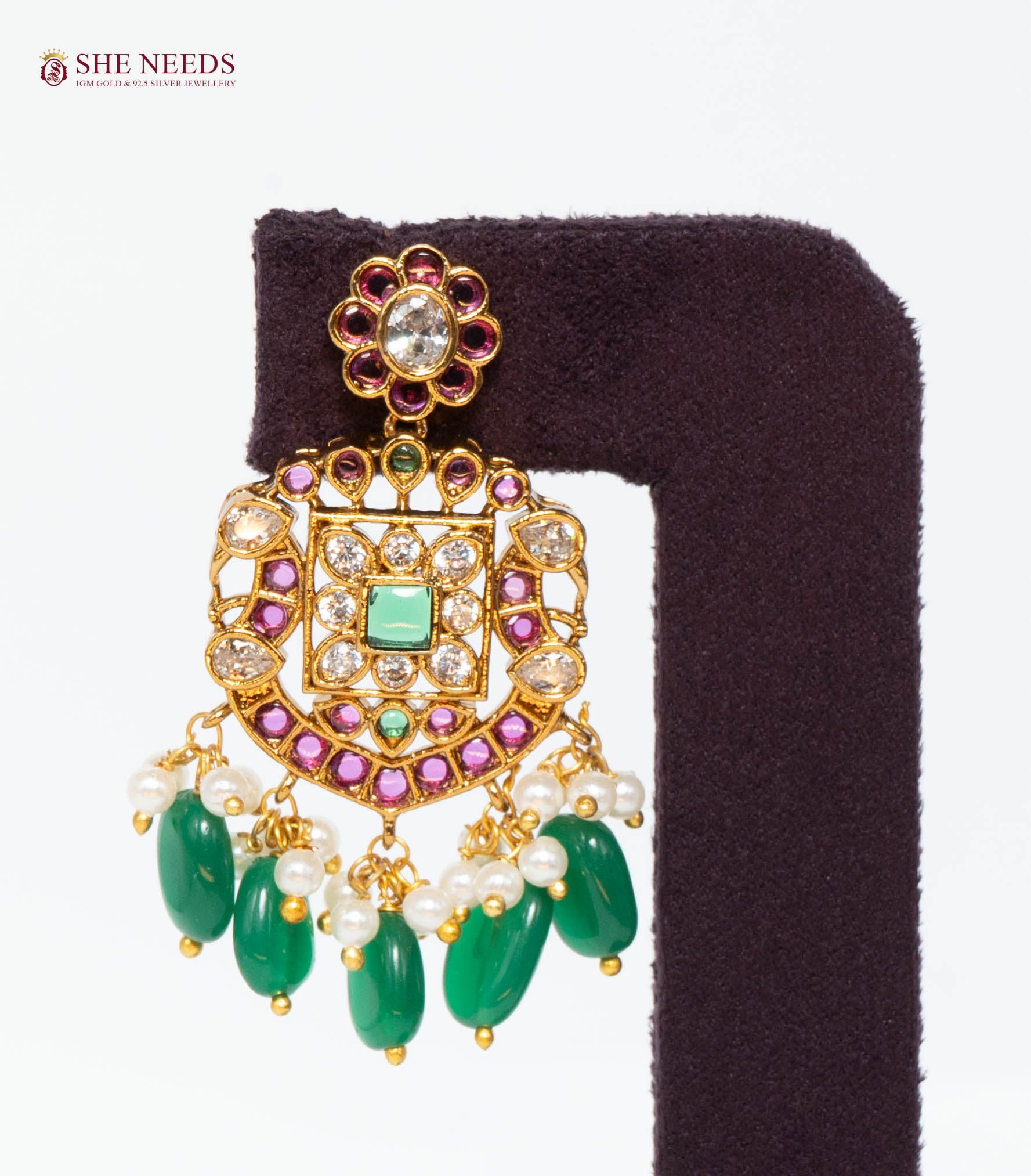 Single royal gold temple drop earring featuring American Diamond stones, green bead drops, pink stone accents, and pearl detailing.|She Needs Jewellery
