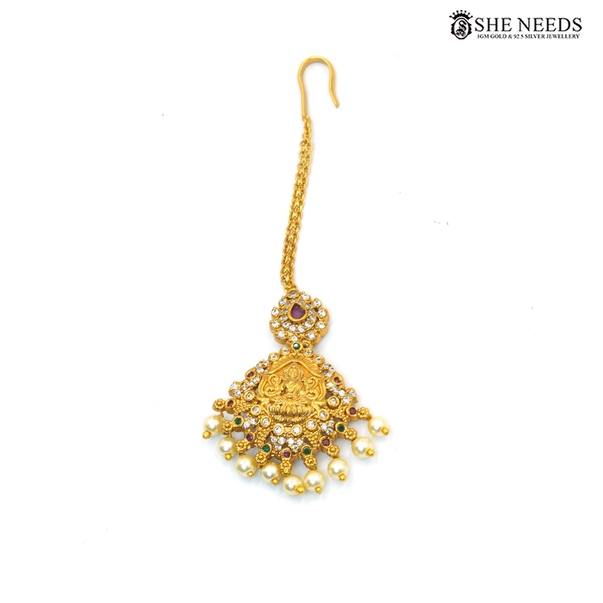 Traditional Lakshmi maang tikka with ruby accents, sparkling stones and pearl drops|She Needs Jewellery
