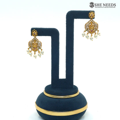 Traditional Lakshmi earrings with ruby and green stone detailing and pearl drops|She Needs Jewellery
