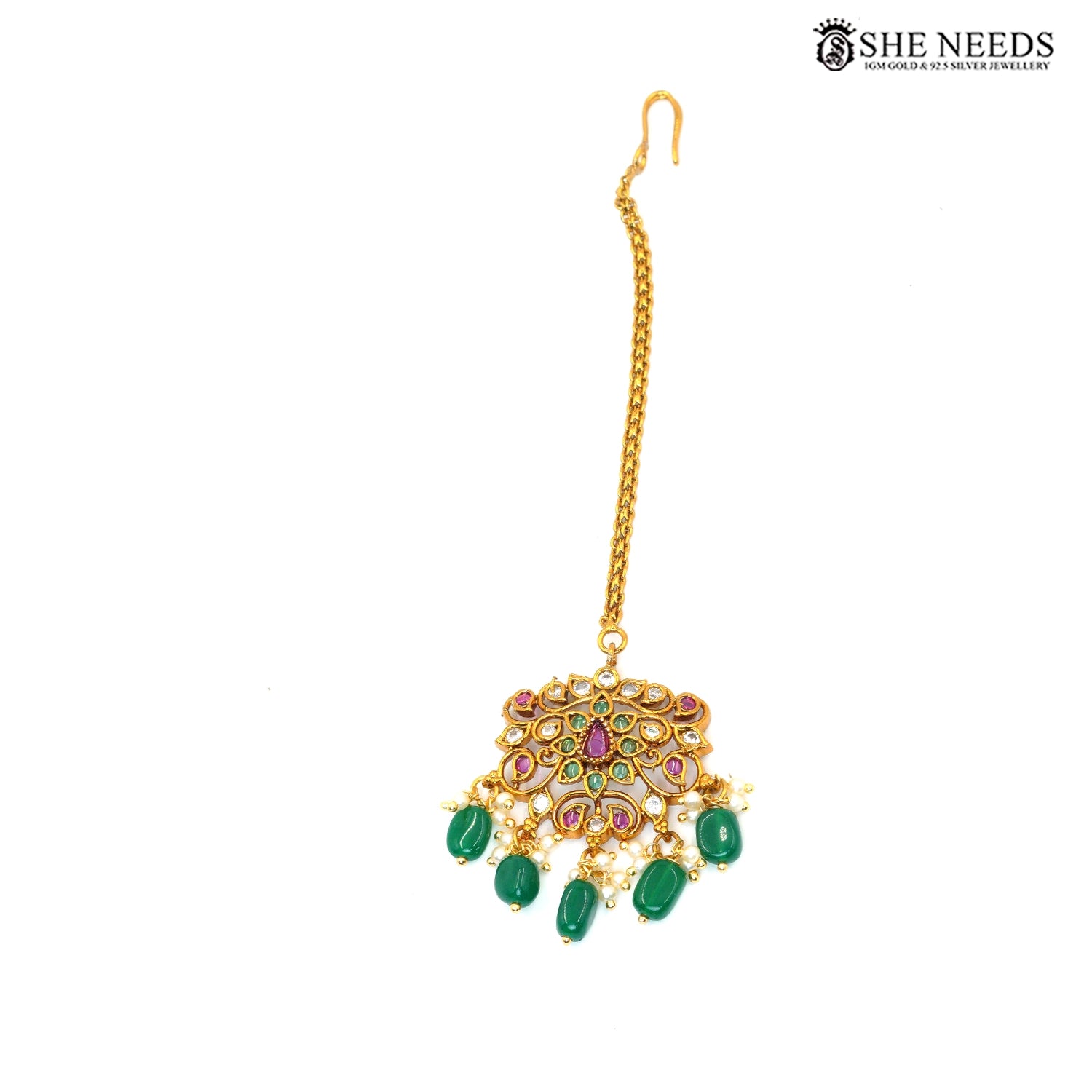 Gold-plated traditional maang tikka with intricate peacock-inspired stonework, green emerald-style beads, ruby accents, white stones and pearl embellishments|She Needs Jewellery
