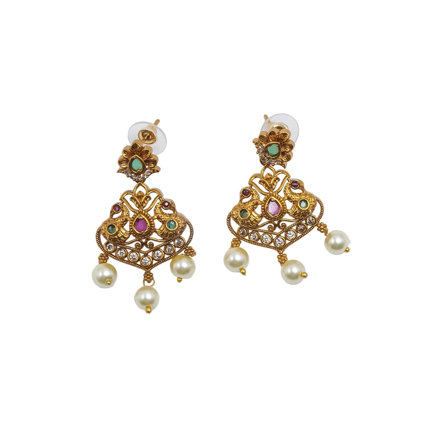 Antique gold earrings featuring peacock-inspired motifs, sparkling kundan stones, ruby-pink and emerald-green accents, intricate filigree craftsmanship, and pearl drop danglers.|She Needs Jewellery
