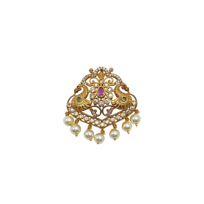 Antique gold pendant featuring twin peacock motifs, sparkling kundan stones, ruby-pink center stone, emerald-green accents, intricate filigree detailing, and elegant pearl danglers.|She Needs Jewellery
