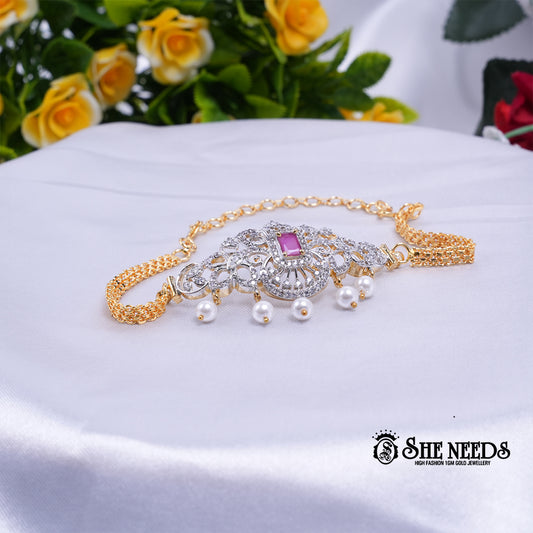 Dual-tone Royal Pearl Stone Baju Band Set featuring sparkling CZ stones, a ruby-pink center stone, intricate floral filigree detailing, and elegant pearl drop accents with an adjustable chain.|She Needs Jewellery
