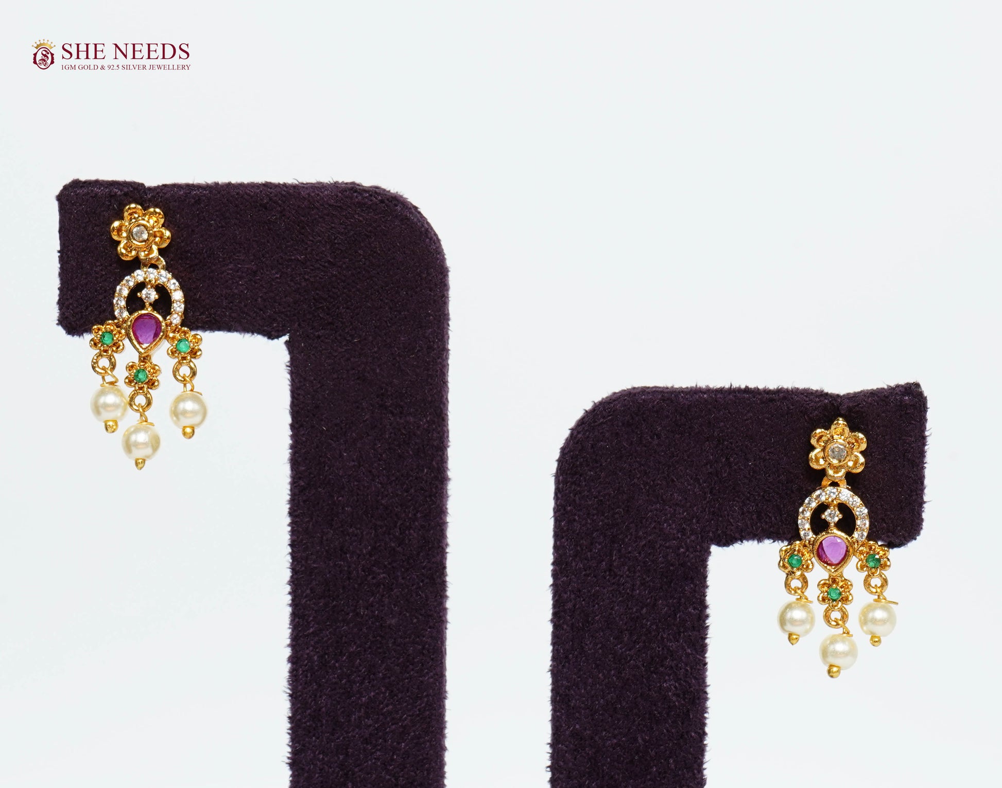 Pair of gold-plated ruby pearl fringe earrings with American Diamond detailing, emerald accents, and hanging pearl drops.