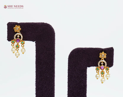 Pair of gold-plated ruby pearl fringe earrings with American Diamond detailing, emerald accents, and hanging pearl drops.