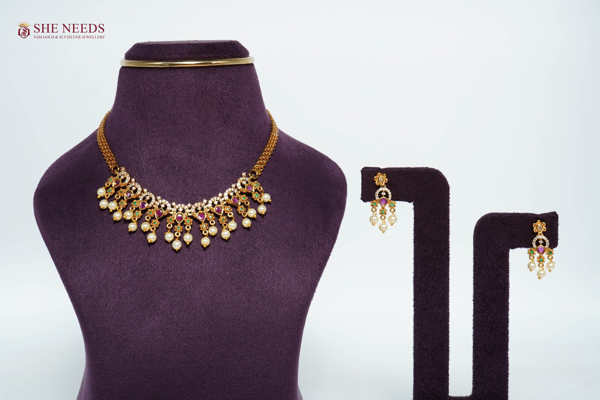 Royal Ruby pearl fringe necklace set with AD stones, emerald accents, pearl drops, and matching traditional earrings.|She Needs Jewellery
