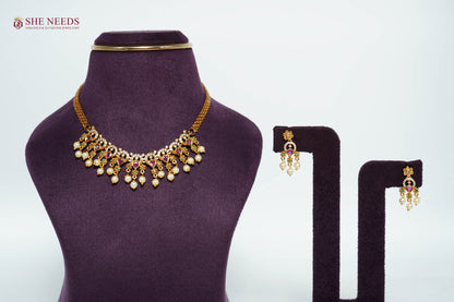 Royal Ruby pearl fringe necklace set with AD stones, emerald accents, pearl drops, and matching traditional earrings.|She Needs Jewellery
