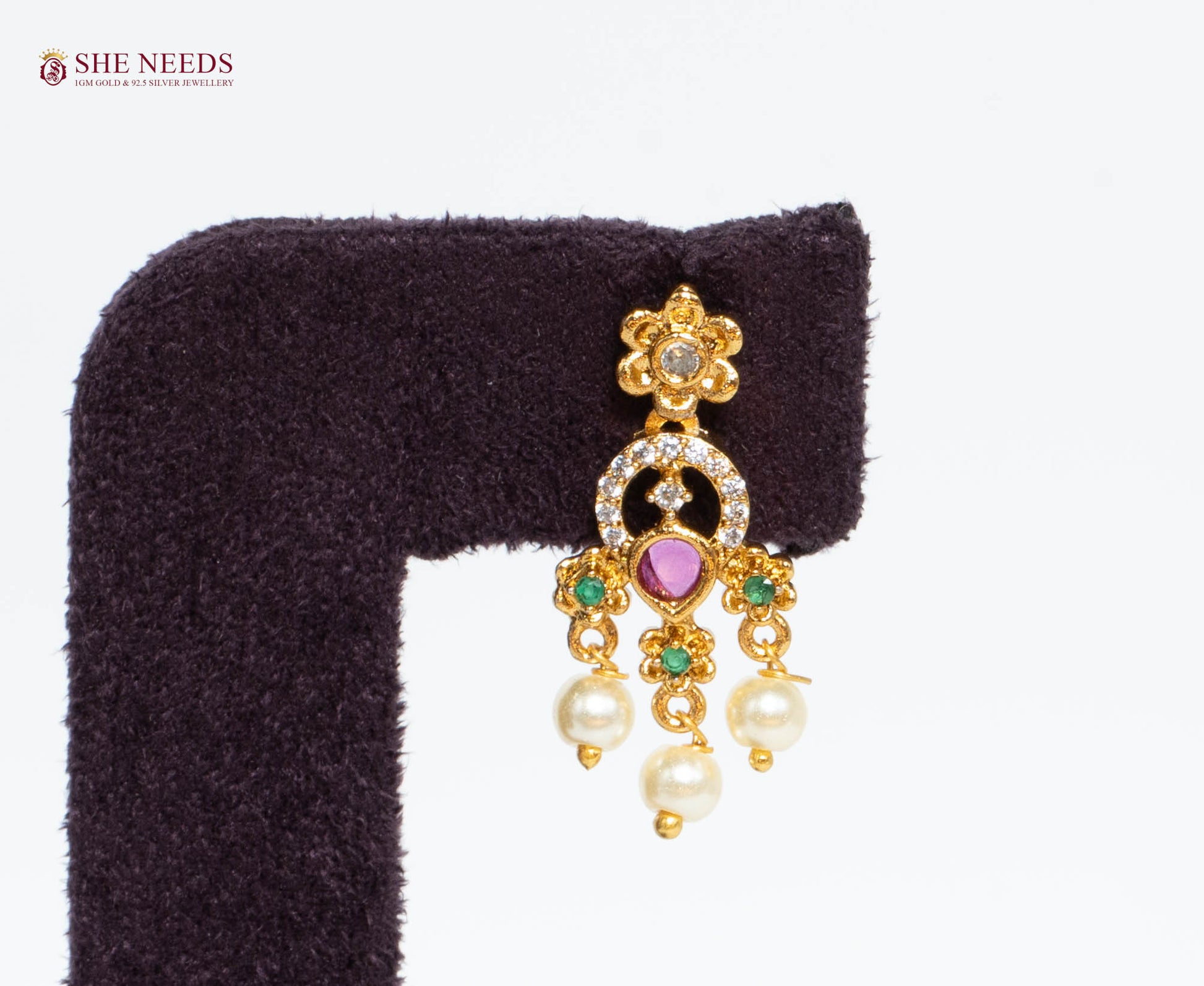 Single gold-plated ruby pearl fringe earring featuring American Diamonds, emerald accents, and pearl drop detailing.|She Needs Jewellery
