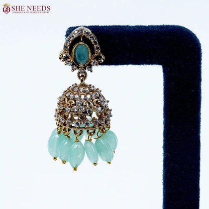 Royal Stone Antique Light Green Jhumka Earrings featuring sparkling American Diamonds, antique gold detailing, light green stone, and light green crystal drops. She Needs Jewellery