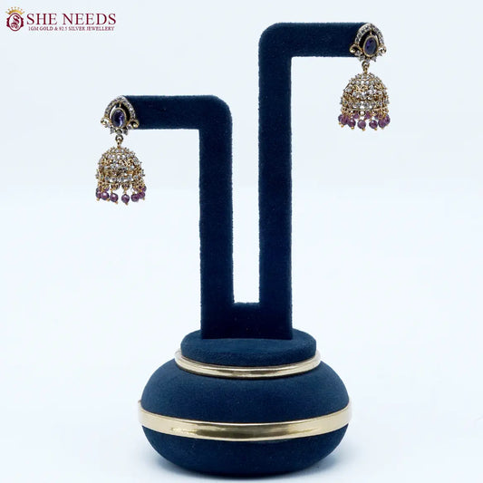 Royal Stone Antique Purple Jhumka Earrings featuring sparkling American Diamonds, antique gold detailing, purple stone centerpiece, and purple crystal bead drops.|She Needs Jewellery
