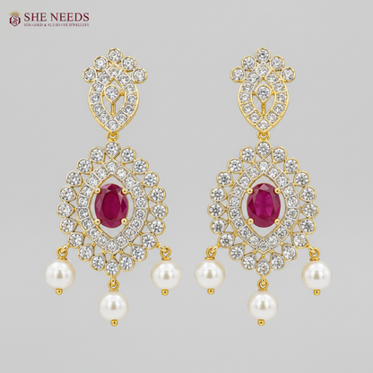 Elegant ruby pink AD stone bridal necklace set with pearl drop earrings in premium gold finish displayed on white mannequin.