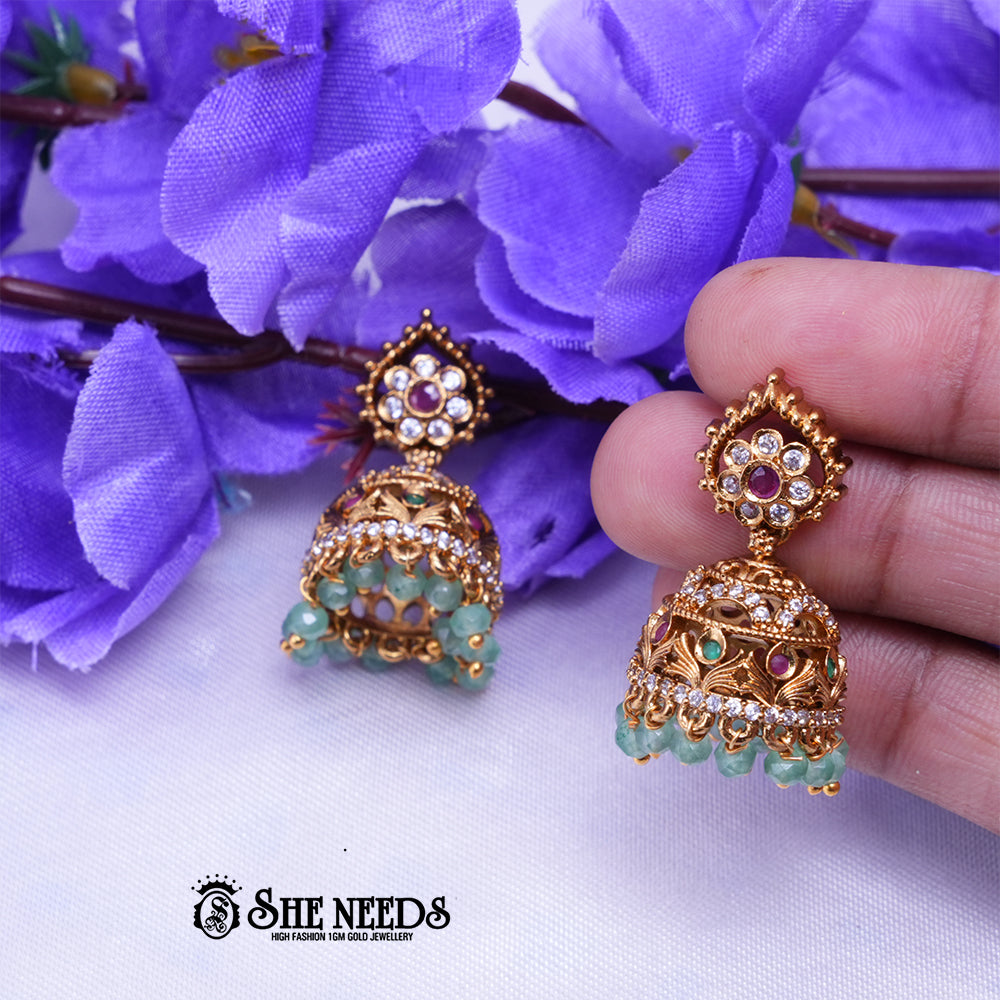 Antique temple jhumka earrings with CZ stones and pearl drops in intricate traditional Indian design