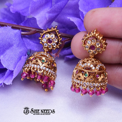 Antique temple jhumka earrings with CZ stones and pearl drops in intricate traditional Indian design