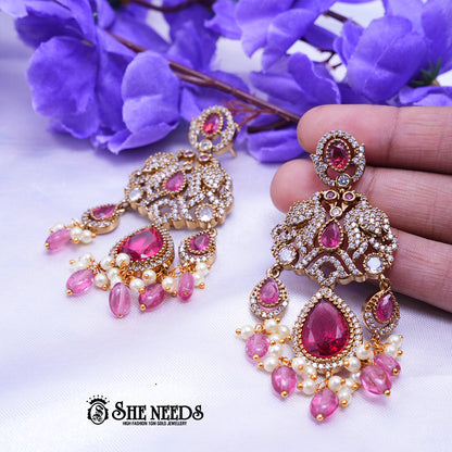 Designer CZ stone chandbali earrings with teardrop stones and pearl bead drops for bridal wear