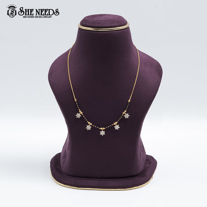 Gold-tone Star Charm Mangalsutra featuring sparkling CZ star-shaped charms, traditional black bead detailing, and a delicate chain design displayed on a jewelry bust.