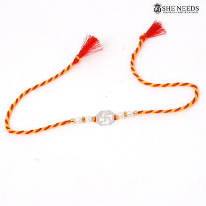 Swastik 925 silver Rakhi with pearl beads, sparkling stones and red-yellow braided thread|She Needs Jewellery
