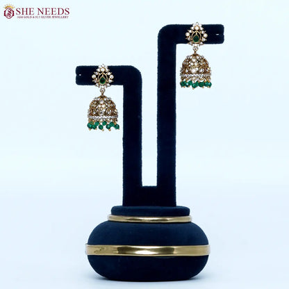 Gold plated traditional jhumka earrings with emerald green bead drops and sparkling zircon stones for women|She Needs Jewellery