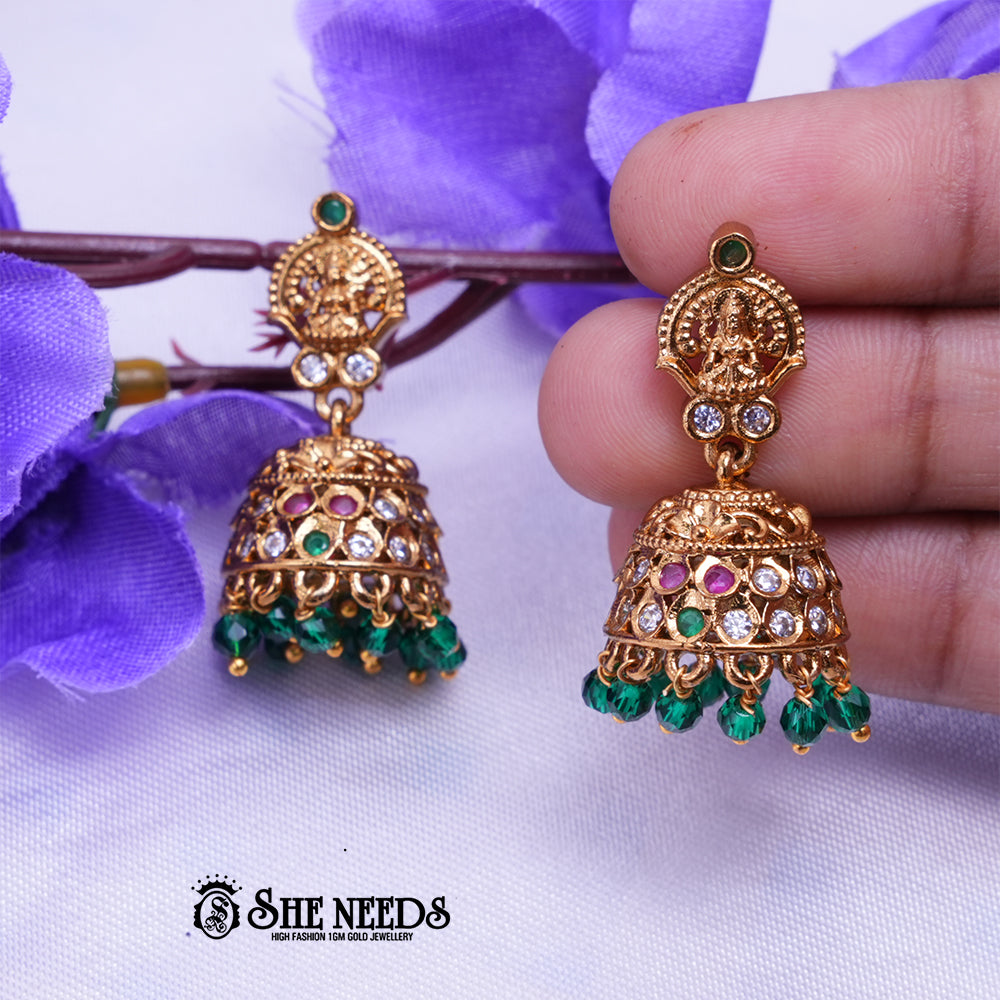 Temple Lakshmi gold jhumka earrings with Green stones and bead drops by She Needs Jewellery