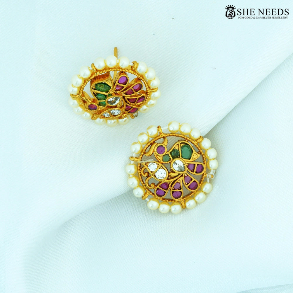 Pair of Vamika Antique Gold Pearl Floral Stud Earrings featuring pearl border, floral swirl design, ruby-colored stones, emerald-colored stones and American Diamonds.|She Needs Jewellery
