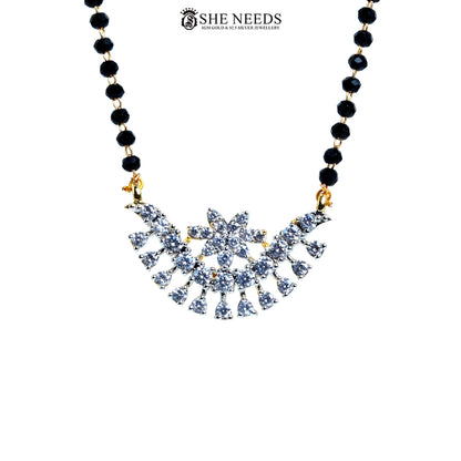 Close-up of Vanya Gold Plated AD Floral Mangalsutra featuring a sparkling floral American Diamond pendant with black bead chain.|She Needs Jewellery
